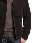 Close-up of a person wearing a dark jacket with a zipper on a white background